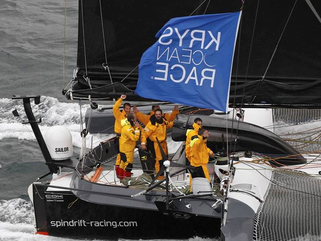 All smiles as Yann Guichard and the crew of the 70-foot trimaran Spindrift cross the finish of the Krys Ocean Race from New York to Brest