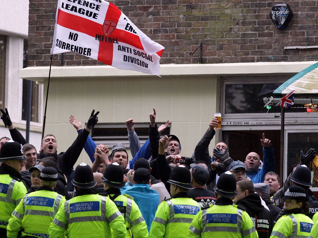 EDL members demonstrate behind police in Bristol today