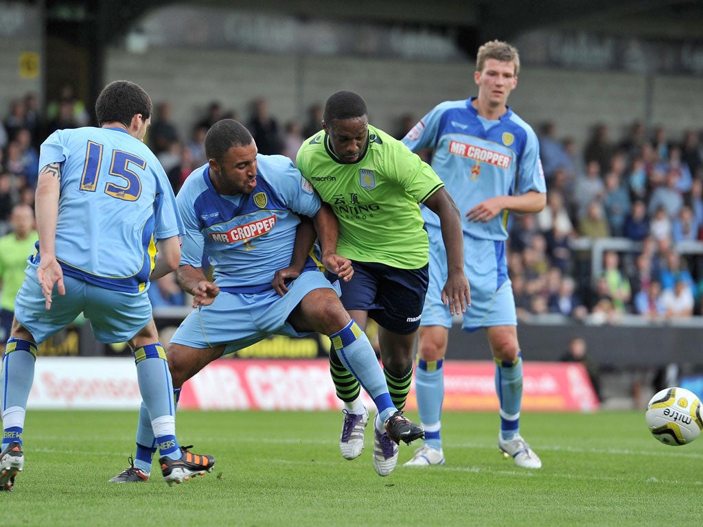 Push and shove: Aston Villa's Charles Nzogbia battles with Burton Albion's Marcus Holness during yesterday's pre-season friendly