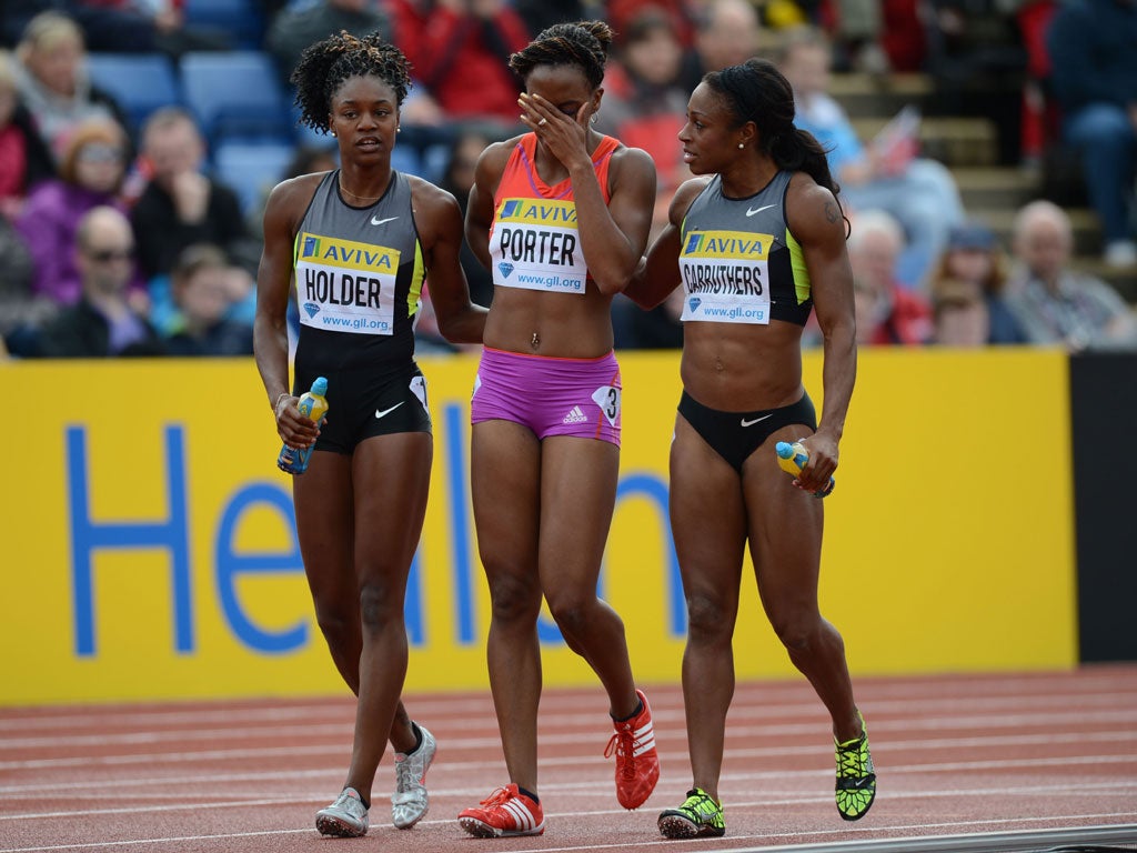 Hurdle Hell: Tiffany Porter (GB) is helped by Canada's Nikkita Holder and Danielle Carruthers of the US