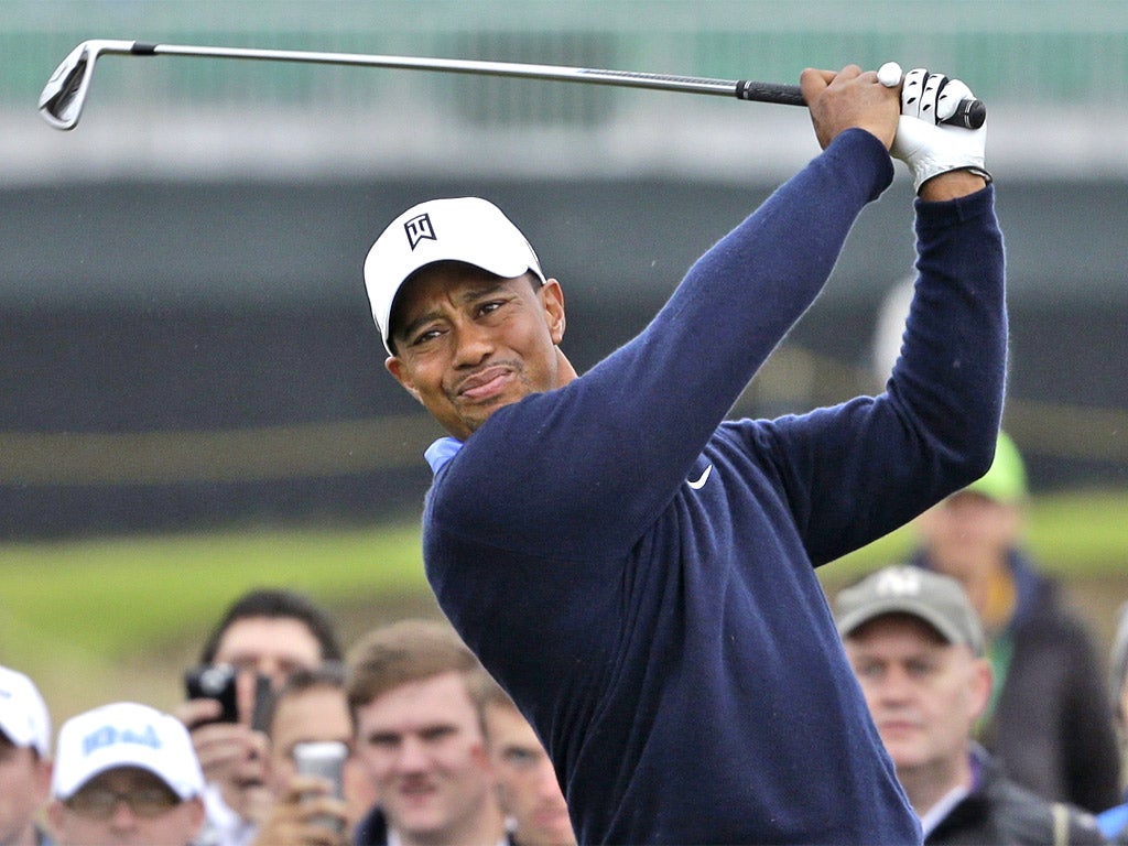 Tiger Woods plays a shot off the 18th tee during practice yesterday