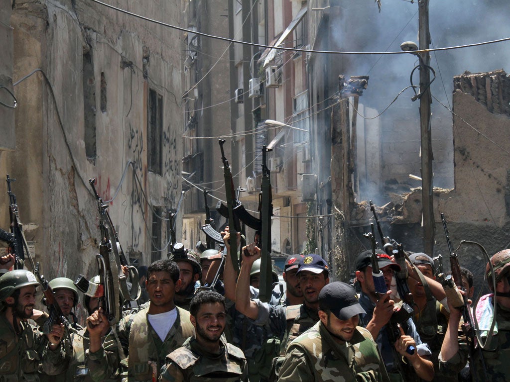 Regime troops celebrate after taking Midan in Damascus