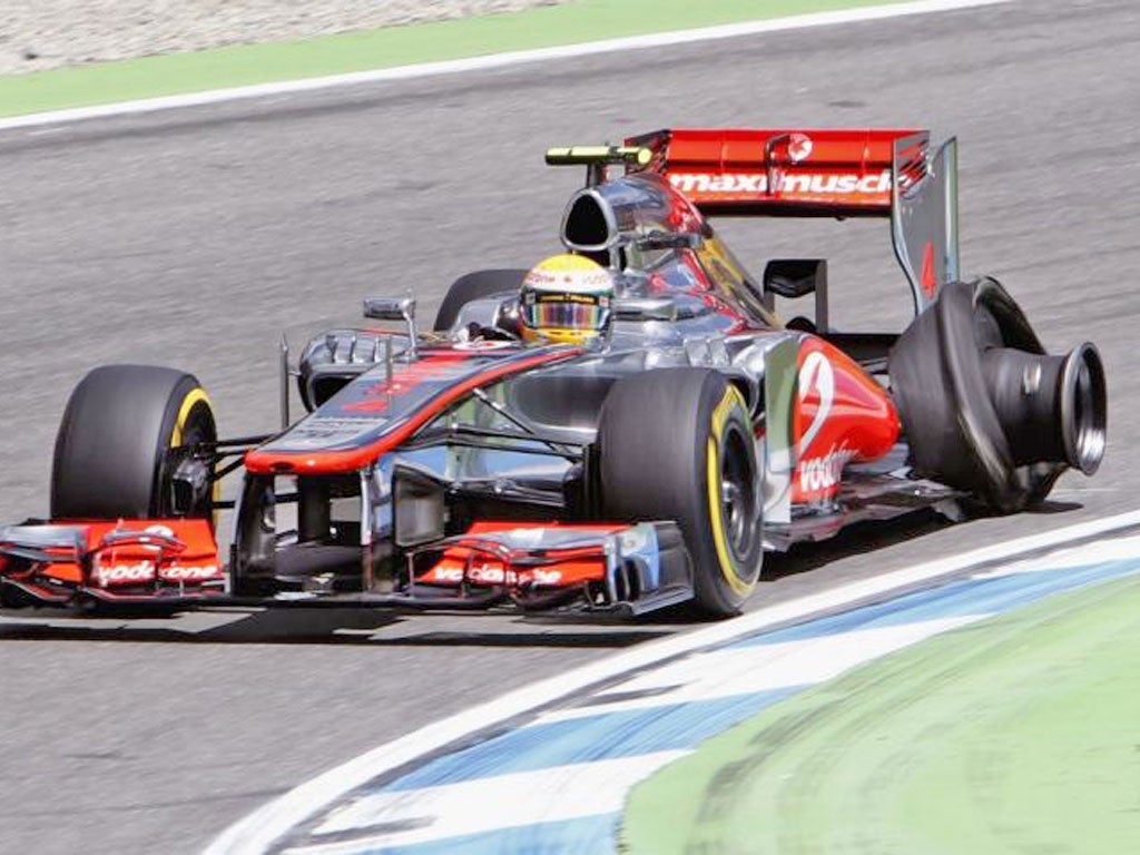 Lewis Hamilton limps round the track with a damaged tyre after
hitting debris