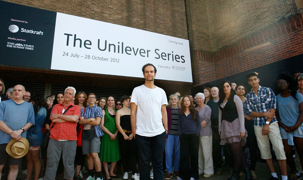 Artist Tino Sehgal is photographed with participants outside Tate Modern in London.