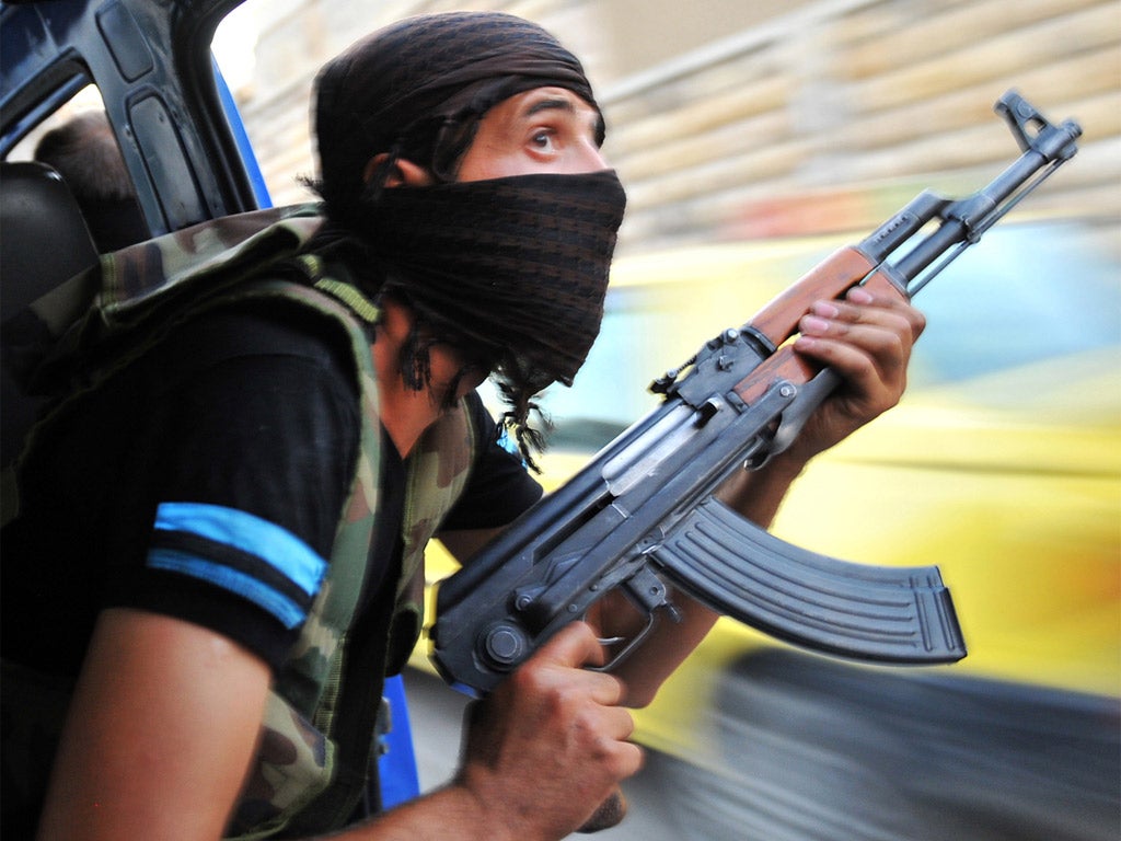 A Syrian rebel watches for snipers in Aleppo yesterday