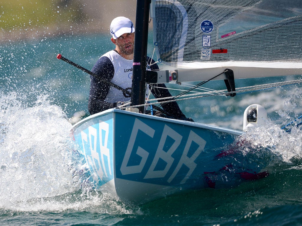 Britain's sailor Ben Ainslie crosses the finish line in a Finn class practice race