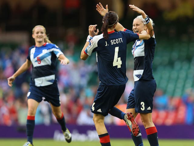 Handy work: Jill Scott celebrates with Steph Houghton after the defender scores Great Britain's third goal