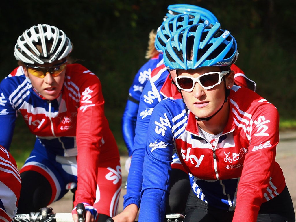 She's behind you: Beijing road race winner Nicole Cooke (left) looks on as Lizzie Armitstead leads her team-mates