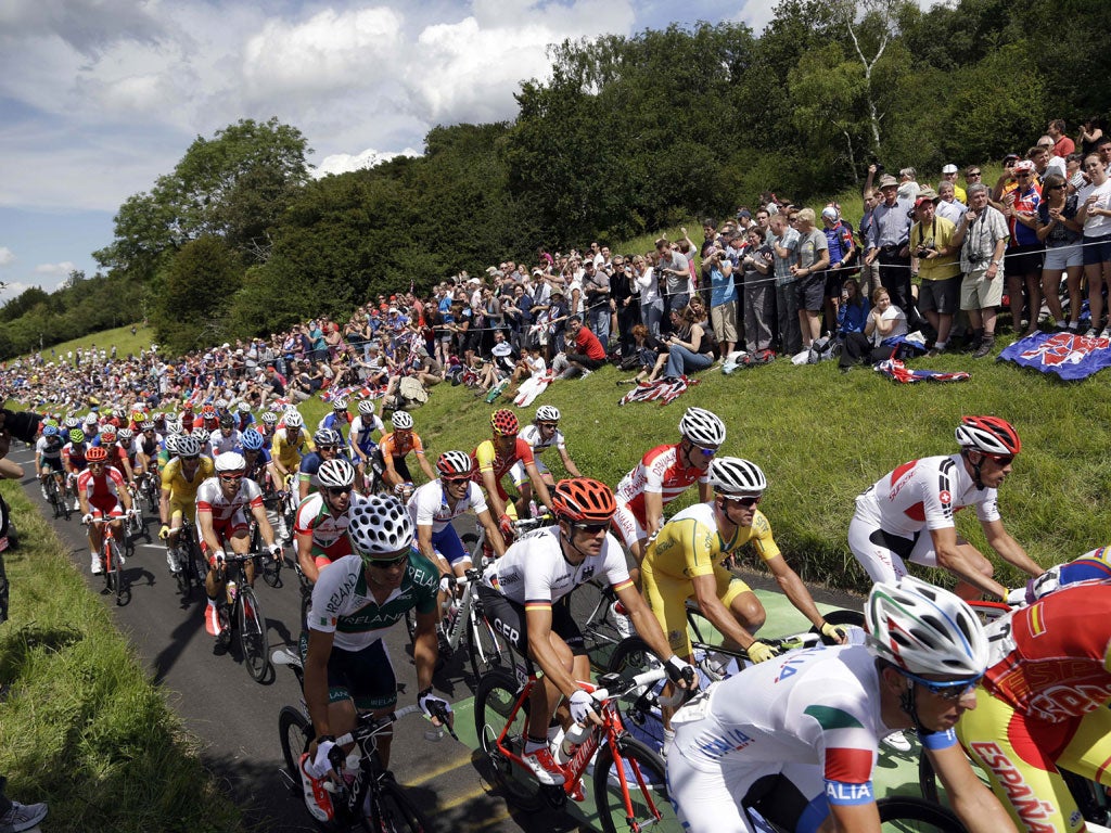 Spectators line the road in Box Hill for the first cycling event
