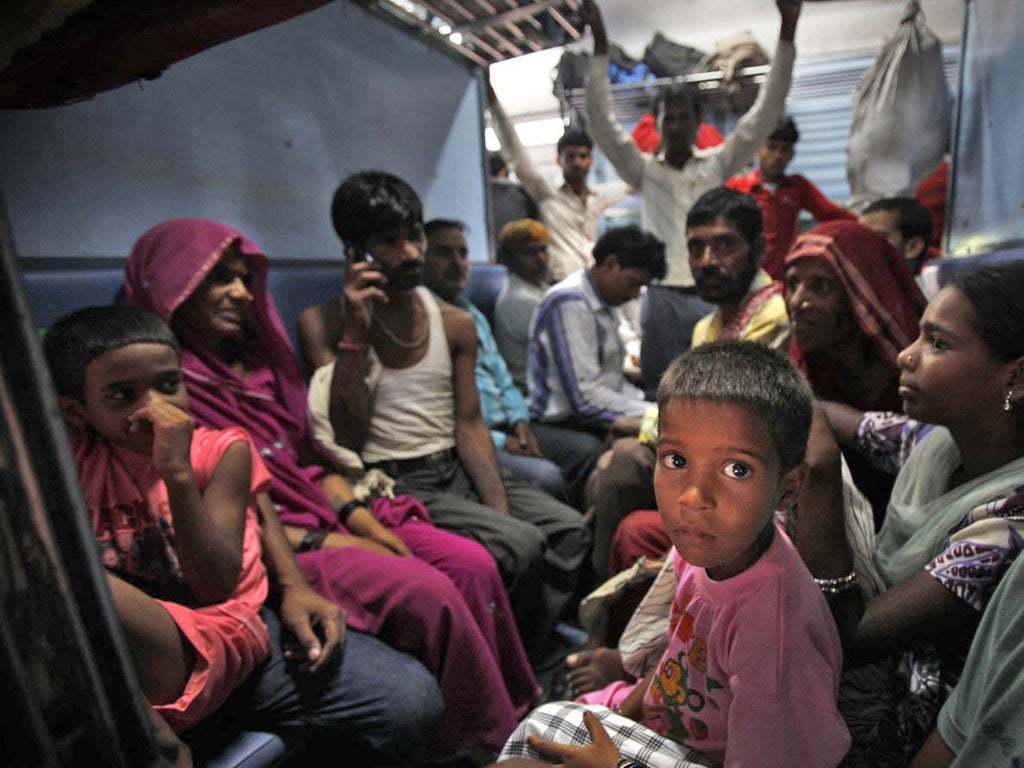 Passengers wait on their train for power to be restored