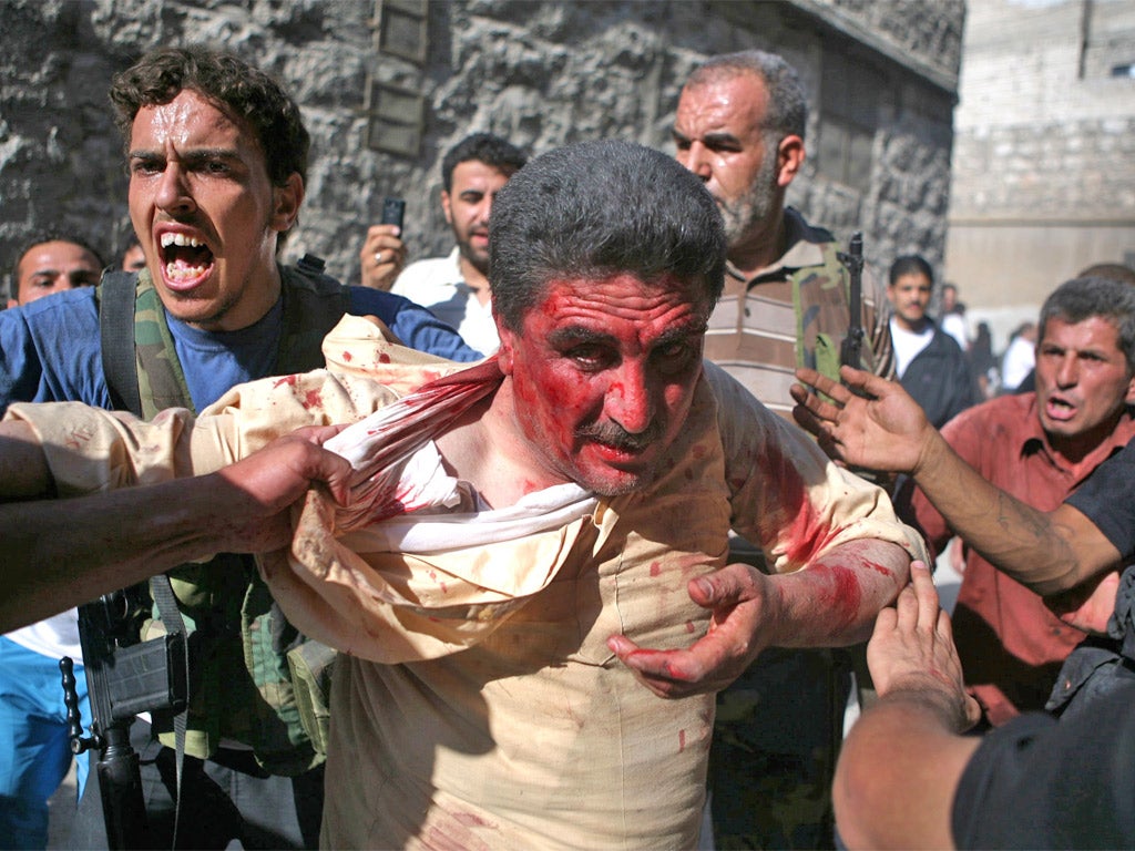Fighters in the rebel Free Syrian Army capture policemen on Tuesday who the FSA claim are Shabiha, or pro-government militiamen, as the rebels overran a police station in Aleppo