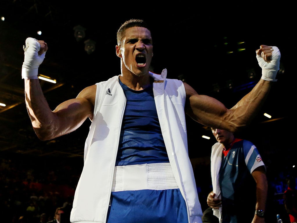 Anthony Ogogo celebrates his victory over world number one middleweight boxer Ievgen Khytrov