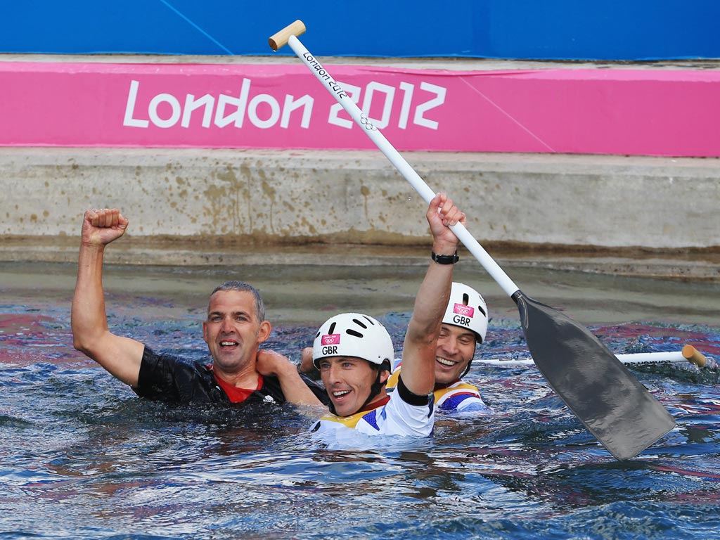August 2, 2012: Gold medalists Etienne Stott (C) and Tim Baillie (R) of Great Britain celebrate after the Men's Canoe Double (C2) Slalom final