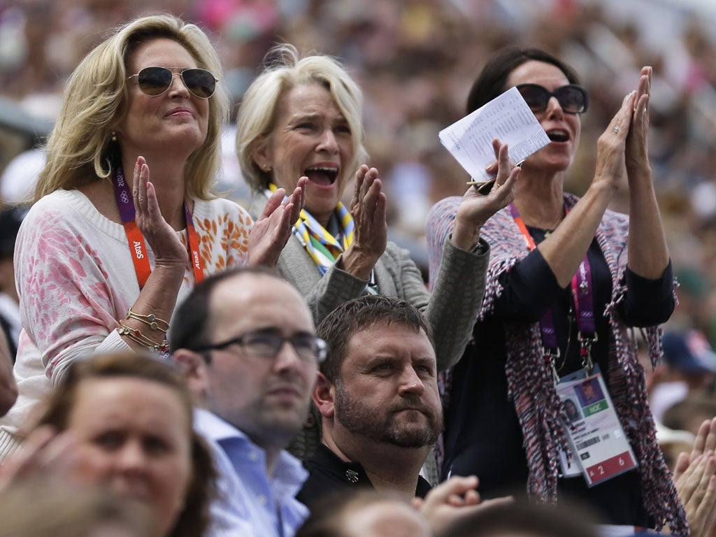 Ann Romney, far left, applauds her horse, ridden by Jan Ebeling