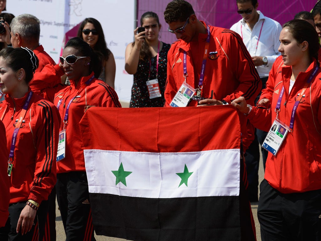 Syrian athletes carry their national flag