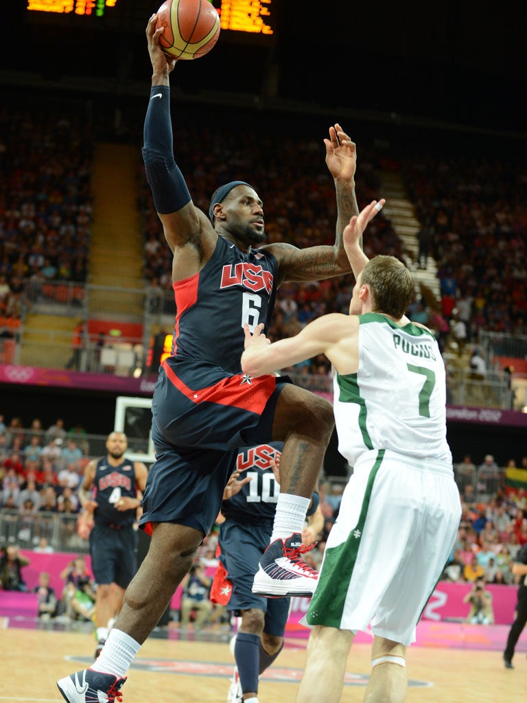 America's LeBron James scores against Lithuania in a close game