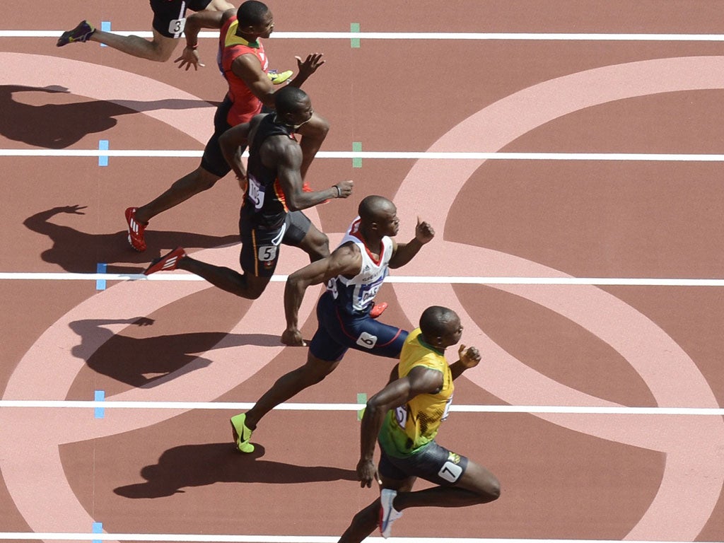 Cruise control: Jamaica's Usain Bolt (bottom) strolls to victory in his 100 metres heat