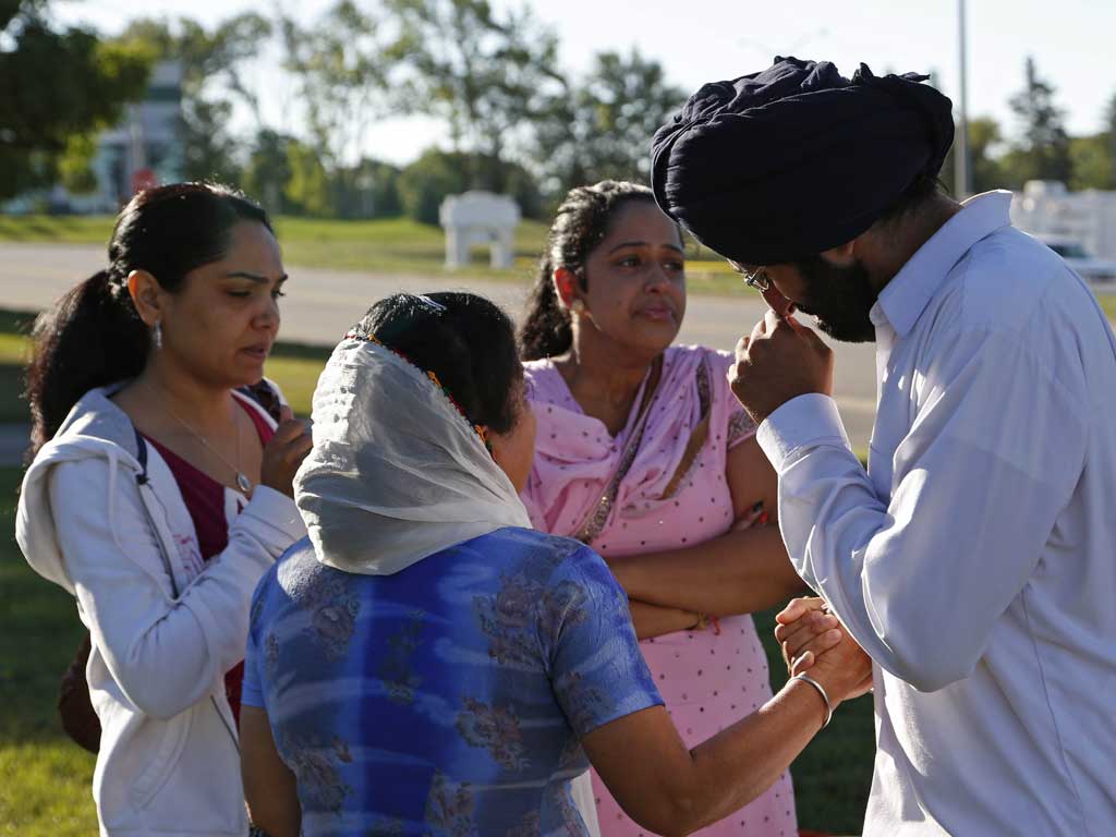 Worshippers console each other near the Sikh Temple of Wisconsin