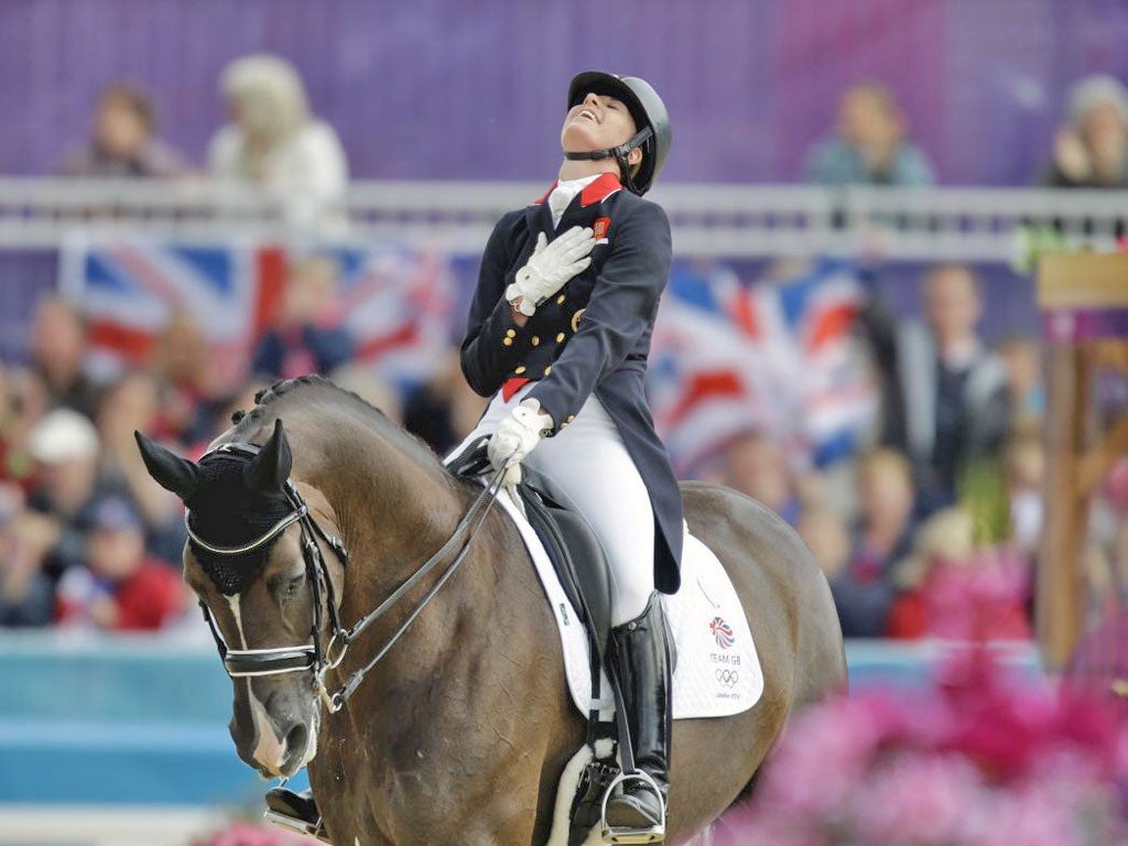 August 7, 2012: Charlotte Dujardin celebrates winning her gold medal in the dressage team competition