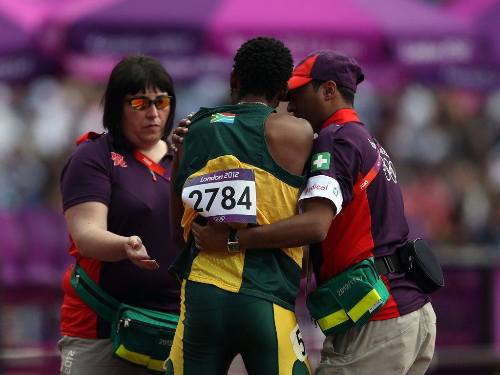 August 9, 2012: Ofentse Mogawane of South Africa receives assitance after crashing out of the men's 4 x 400 metres relay