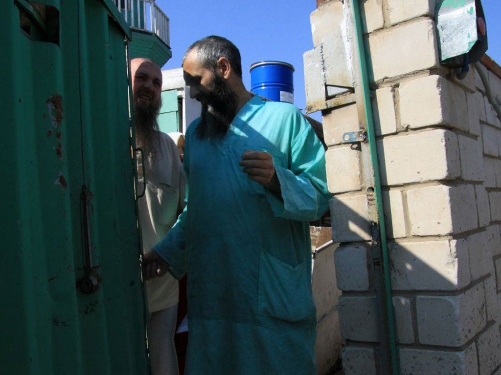 Members of the underground sect in Russia's Volga River province of Tatarstan province stand at the gate of a house outside the provincial capital, Kazan