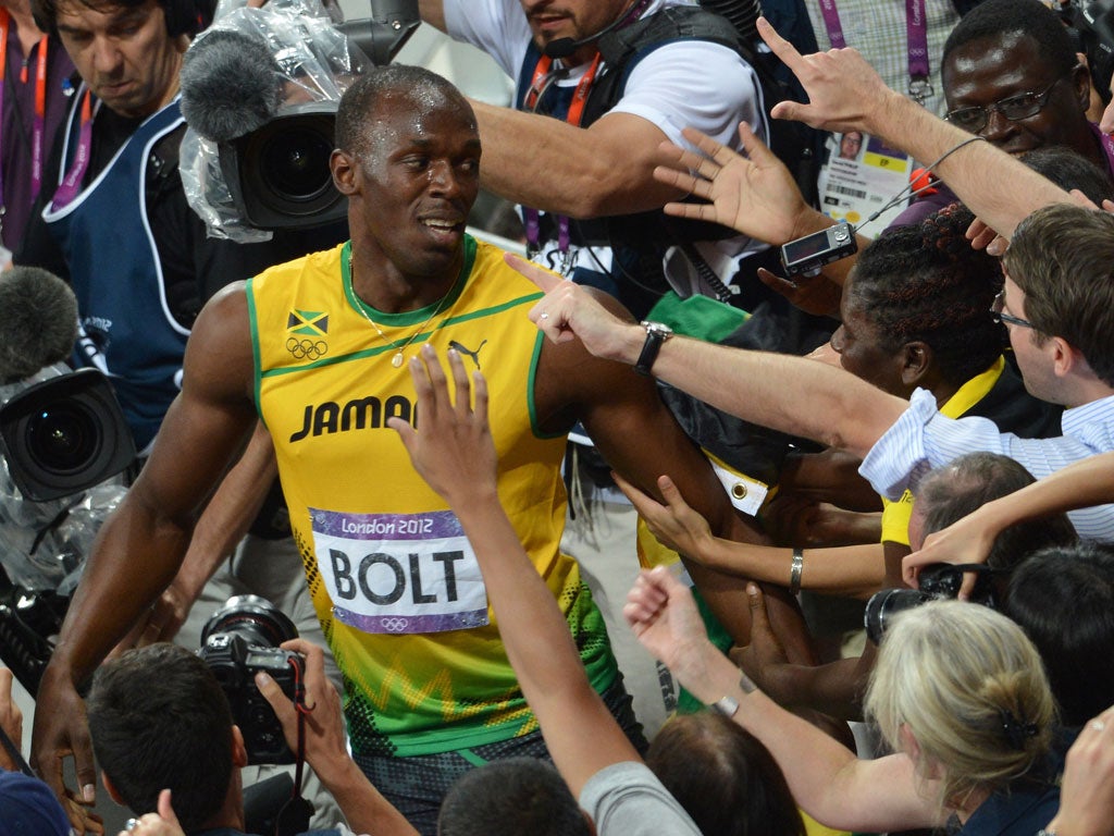 Usain Bolt is mobbed by fans