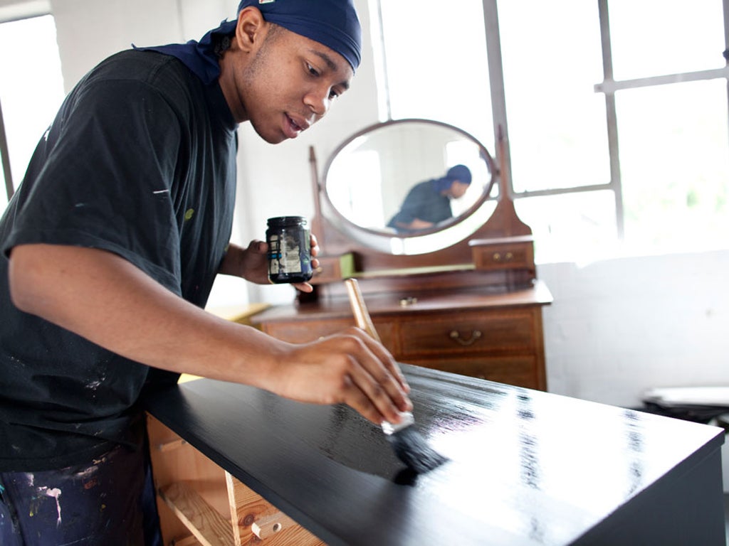 Tyrell varnishes a chest of drawers