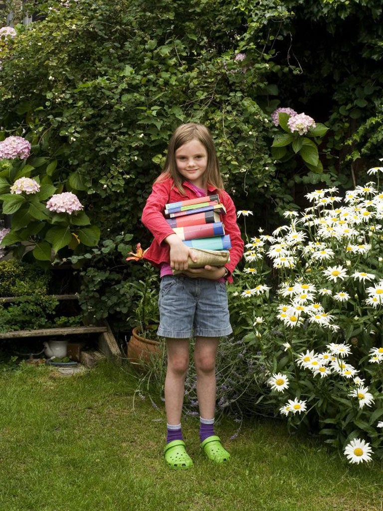 Eve Maume, 7, with her Harry Potter books