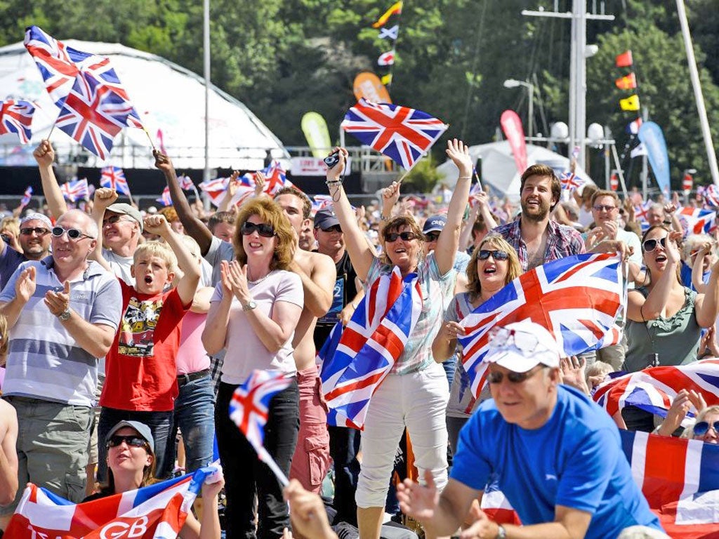 Crowds go wild as they watch Team GB sailor Ben Ainslie win his
fourth Olympic gold on screens at the Weymouth Beach, Dorset