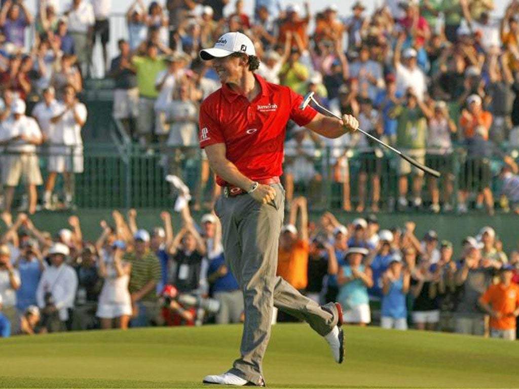 Rory McIlroy is all smiles after sinking a birdie putt on the 18th on Sunday