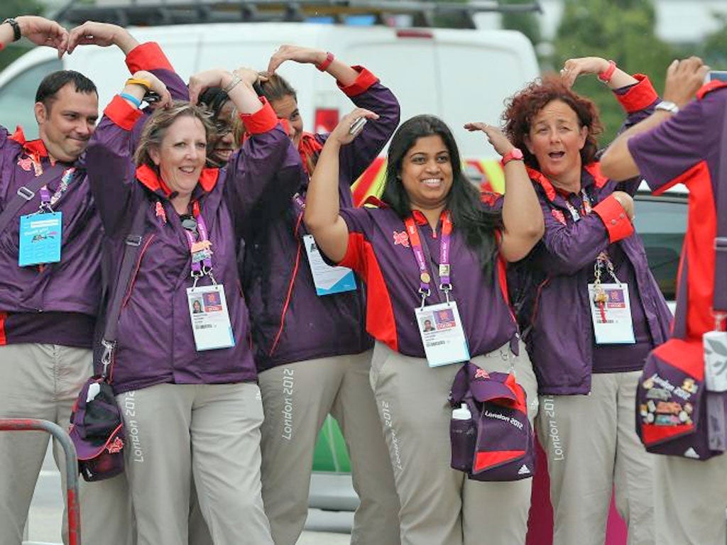 Volunteers do ‘the Mobot’ in tribute to Mo Farah at Heathrow yesterday