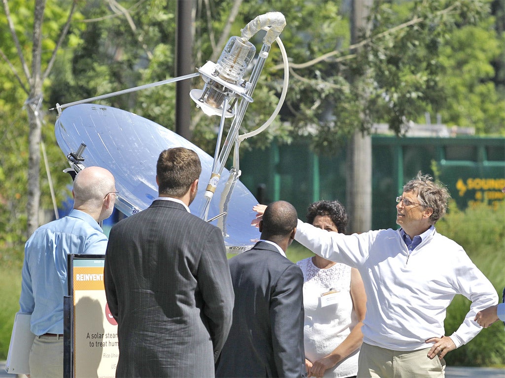 Bill Gates reviews a solar-powered lavatory at the Reinventing the Toilet fair