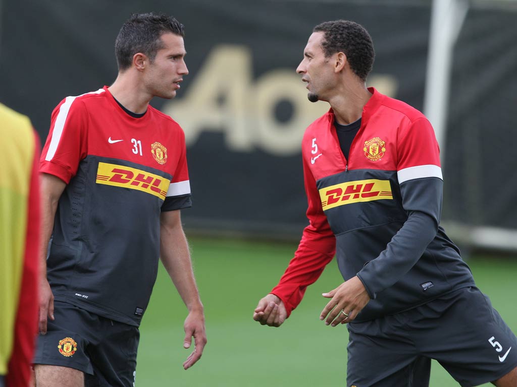 Robin van Persie talks with Rio Ferdinand