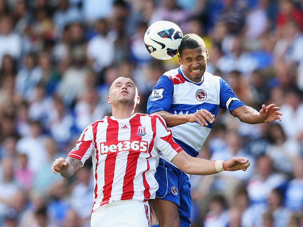 Jobi McAnuff of Reading jumps for a header with Michael Kightly of Stoke City