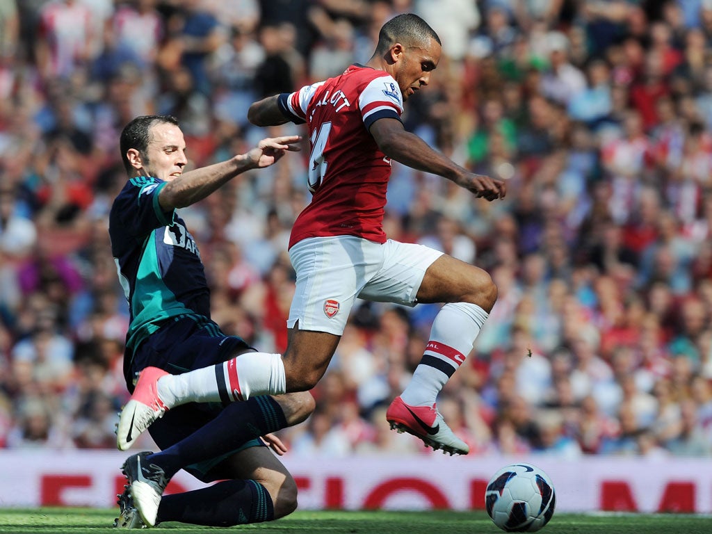 Theo Walcott of Arsenal breaks past John O'Shea
