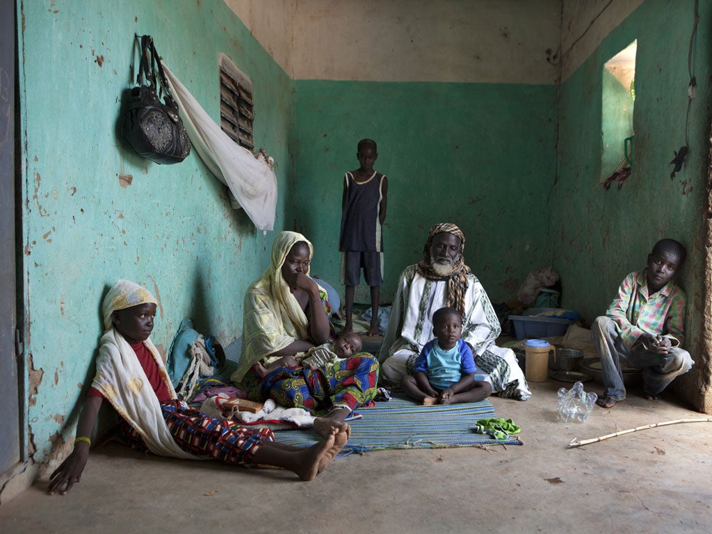 Taking refuge: Koranic master Aboubacrin Sada and his family in Konna, after fleeing Mali's rebel-held north