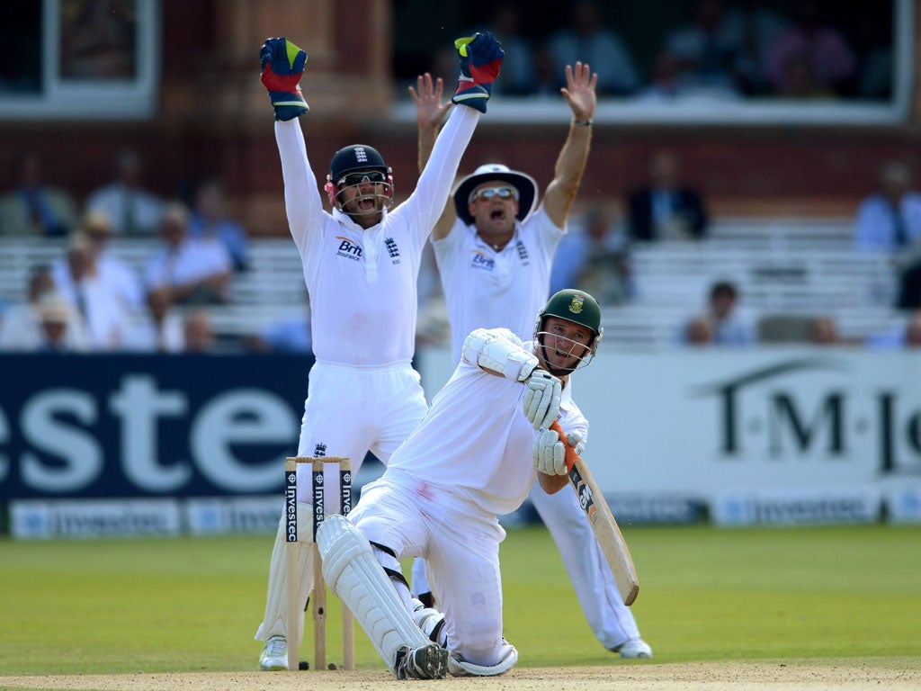 Heat is on: England's Matt Prior and Andrew Strauss successfully appeal for the wicket of Graeme Smith