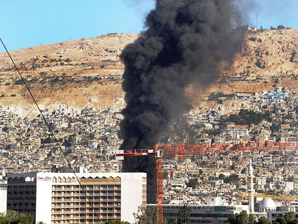 Smoke billows after a bomb on a fuel truck exploded near a Damascus hotel used by the UN, last Wednesday