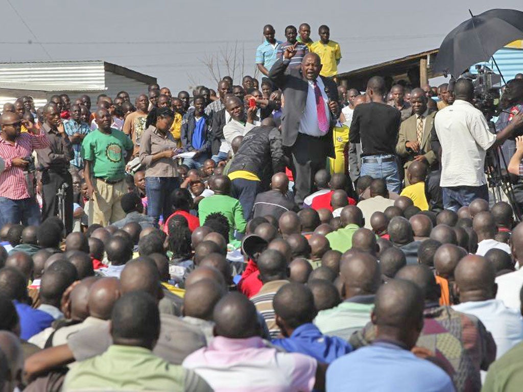 Mosiuoa Lekota of the political party Congress of the People addresses workers at the Marikana mine