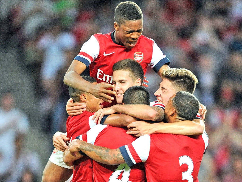 Conor Henderson (centre) enjoys scoring for Arsenal against Bolton this week