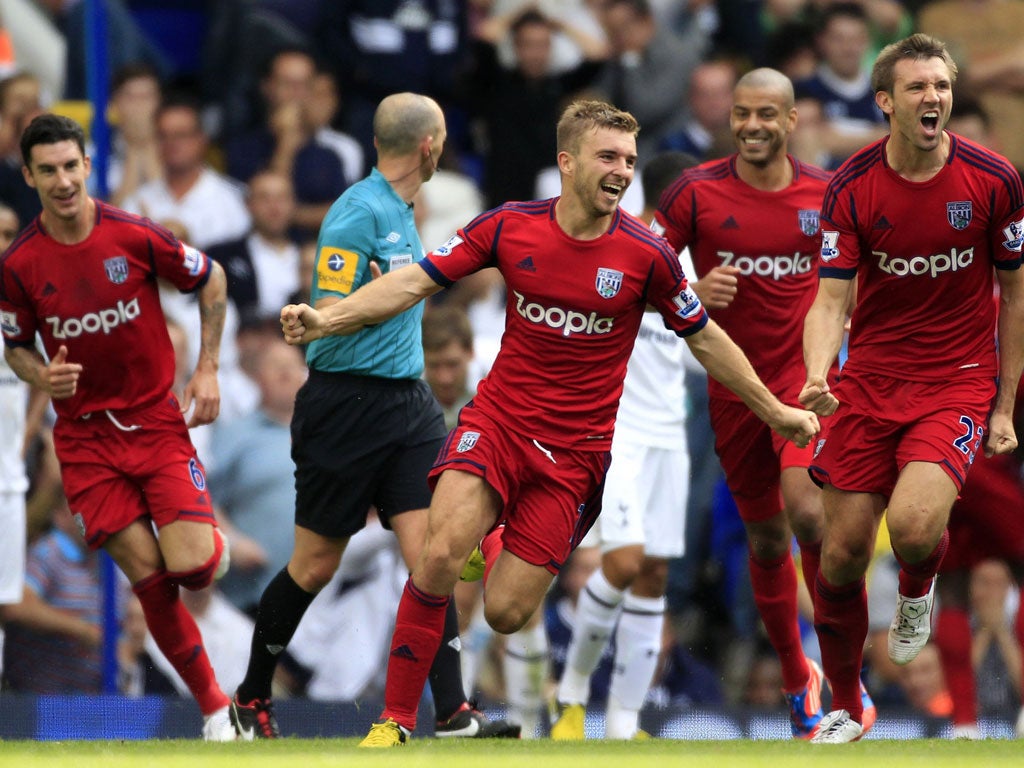 Albion's James Morrison (centre) scores in injury time to give his
side a point at White Hart Lane