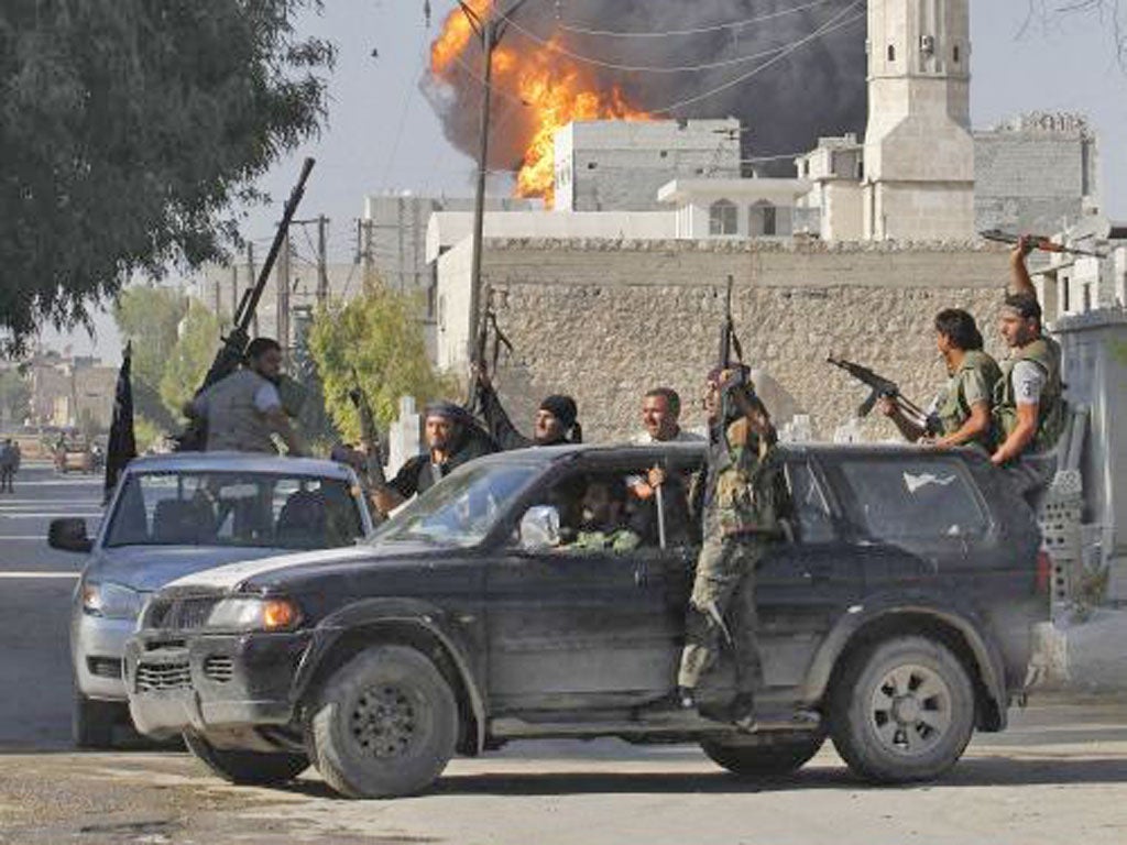 Rebels watch a missile explode in Aleppo yesterday