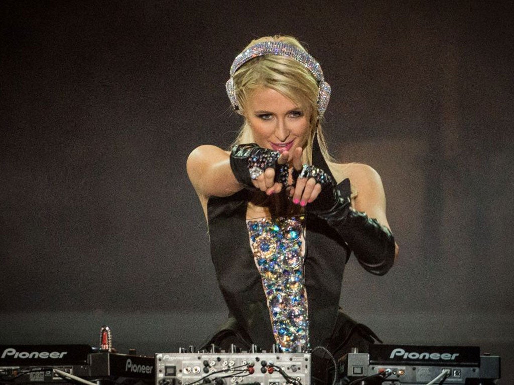 Needle time: Socialite Paris Hilton tries to find the groove