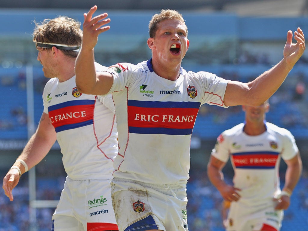 Peter Fox of Wakefield Wildcats celebrates scoring a try