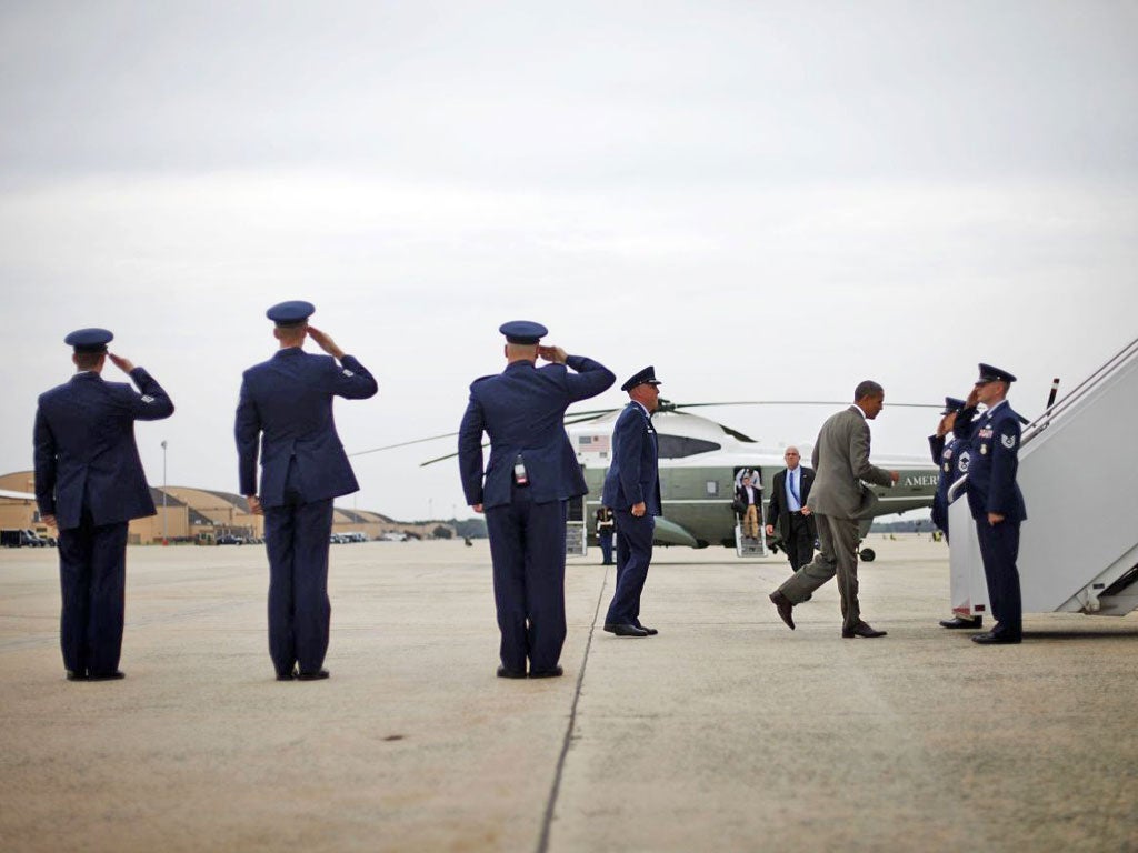 Here he comes: President Barack Obama boards Air Force One to
go campaigning ahead of this week’s Democrat convention