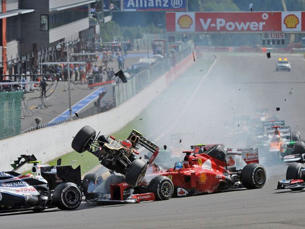 McLaren driver Lewis Hamilton was clipped by Romain Grosjean as he attempted to cut across the Briton