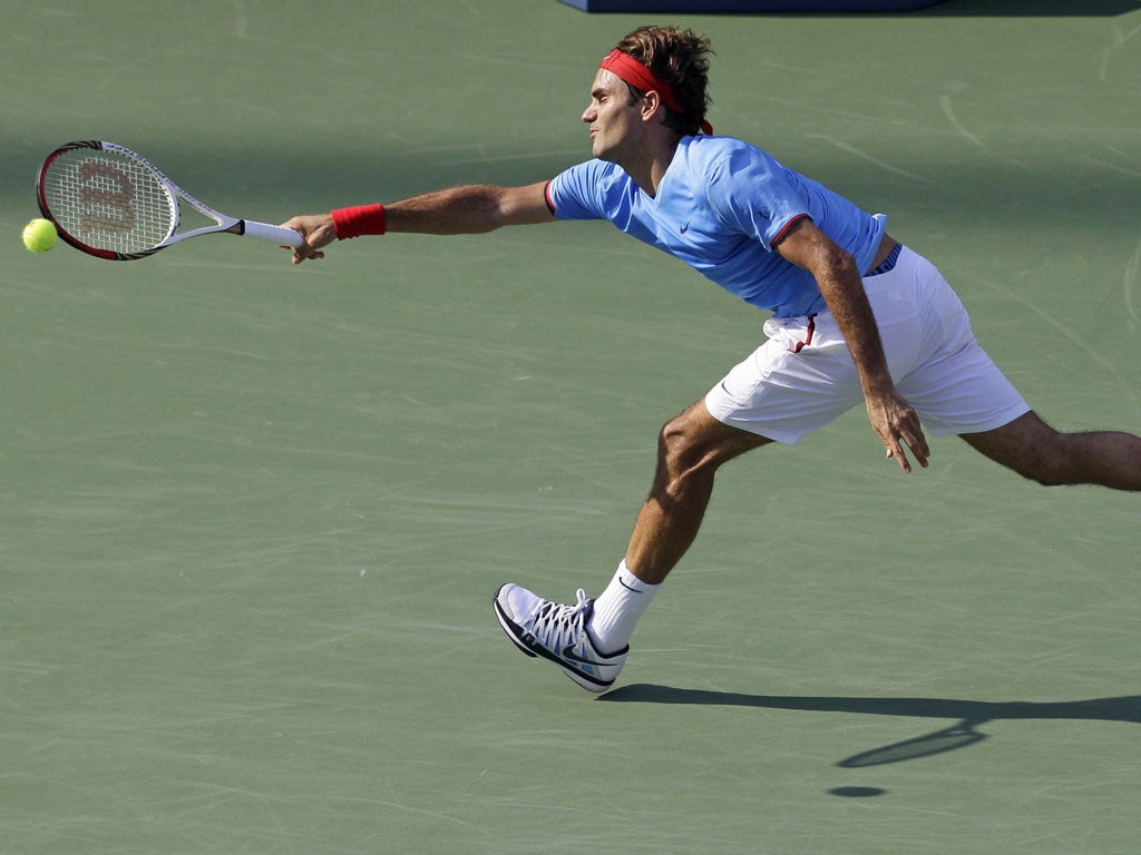 Roger Federer stretches for a return on his way into the last 16 of the US Open at Flushing Meadows