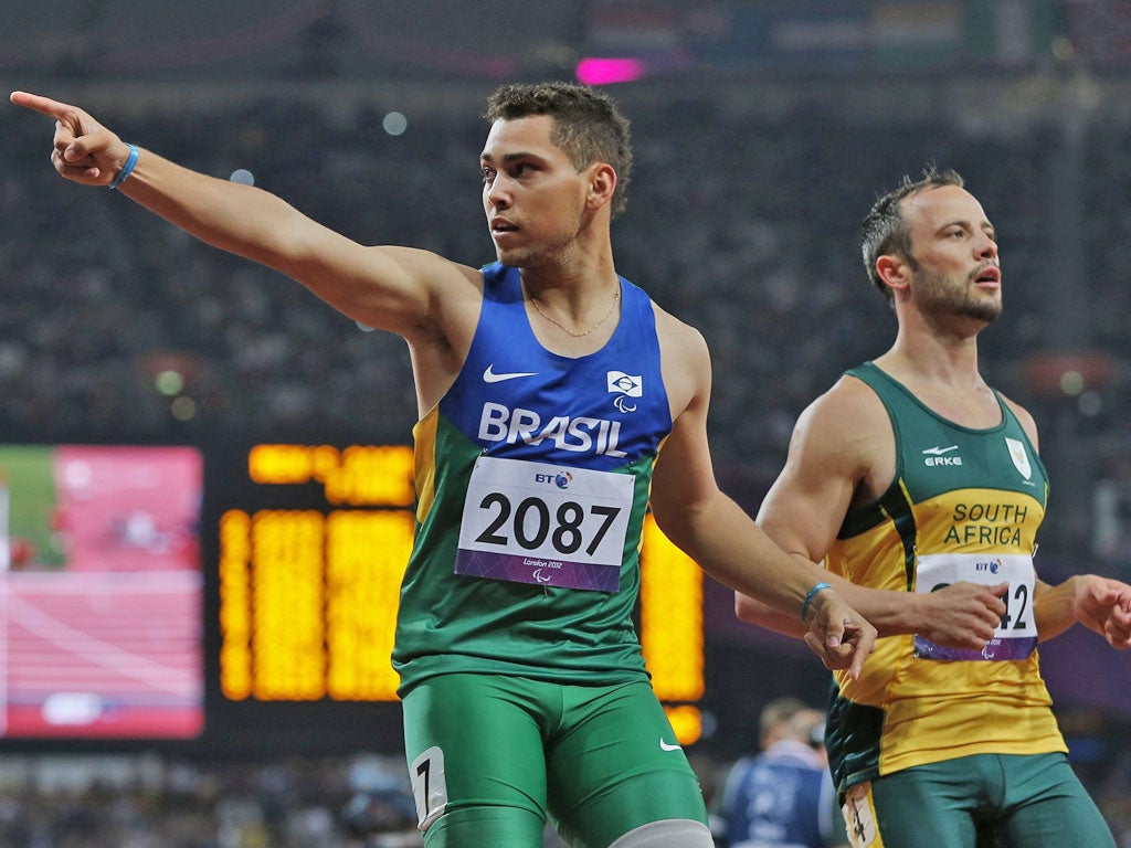 Alan Oliveira (left) celebrates his 200m victory over Oscar Pistorius. Pistorius, the amputee sprinter who won over so many hearts when he competed at the Olympics a few weeks ago, darkened the mood of the Games last night by complaining about the blades used by Oliveira after he was
beaten in the men’s 200m T44 final