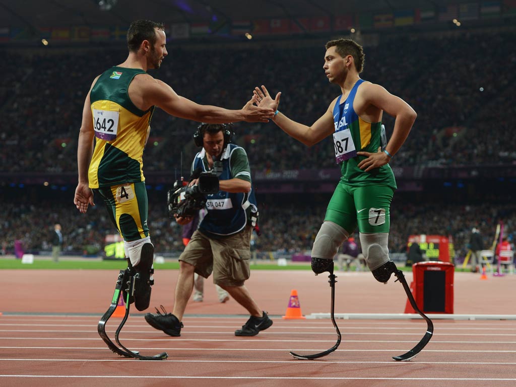 Alan Fonteles Cardoso Oliveira of Brazil is congratulated by Oscar Pistorius