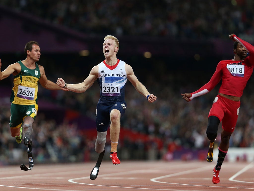 Jonnie Peacock crosses the line to win gold in the Men's 100m